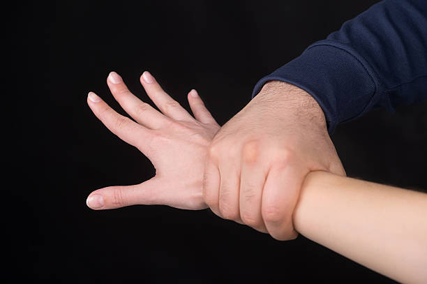 Holding Tight Man holding female hand. Isolated restraining stock pictures, royalty-free photos & images