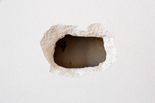 hole hole in a white wall inside a home hole stock pictures, royalty-free photos & images