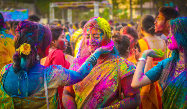 Holi Celebration A Group of friends playing with colors in Holi at Kolkata, India. holi photos stock pictures, royalty-free photos & images