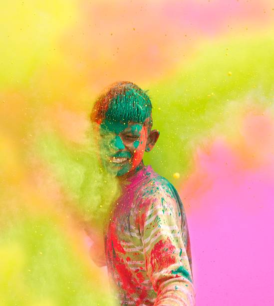 Holi festival celebrations in India. Close-up of a young boy playing Holi in India. holi photos stock pictures, royalty-free photos & images