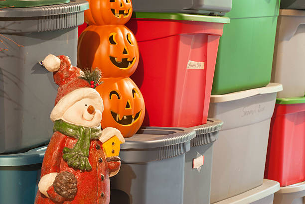 Holiday Decoration Storage Plastic storage bins, filled with decorations for various holidays. storage unit stock pictures, royalty-free photos & images