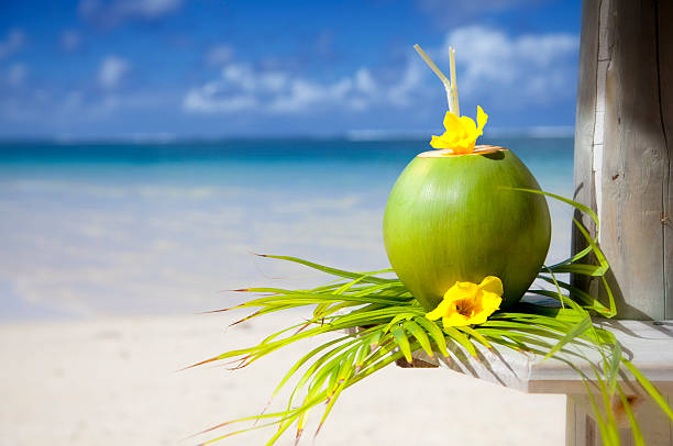 Holiday Feelings Coconut at the beach of Mauritius. coconut milk stock pictures, royalty-free photos & images