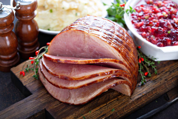 Holiday glazed ham for Christmas Holiday glazed ham for Christmas dinner with cranberry sauce ham stock pictures, royalty-free photos & images