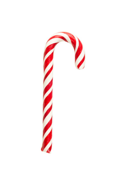 Holiday red and white striped candy cane, isolated Holiday sweet candy in the form of a red-white striped stick of a cane, isolated candy cane stock pictures, royalty-free photos & images