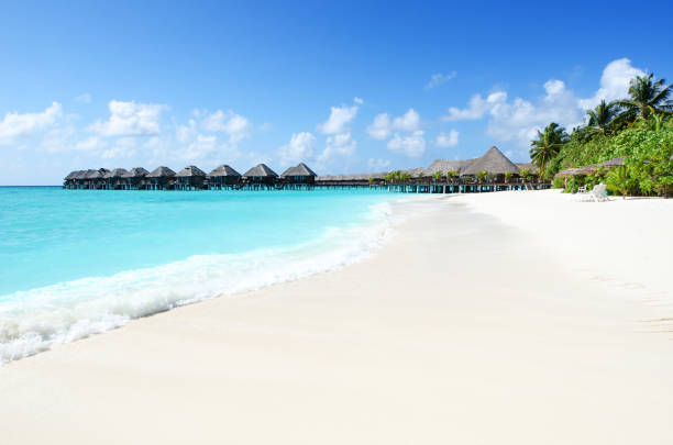 Holiday villas in lagoon,Tropical paradise beach resort of Maldives. stock photo
