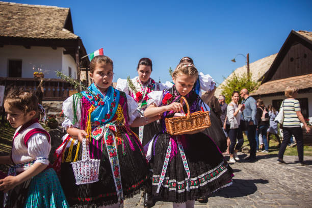 Holloko in Hungary HOLLOKO, HUNGARY - April 12, 2019: Easter festival in the folklore village of Holloko in Hungary. Girls dressed in national costumes according to tradition unesco organised group stock pictures, royalty-free photos & images