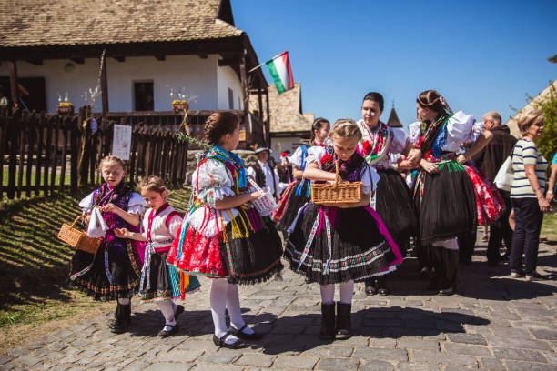 Holloko in Hungary HOLLOKO, HUNGARY - April 12, 2019: Easter festival in the folklore village of Holloko in Hungary. Girls dressed in national costumes according to tradition unesco organised group stock pictures, royalty-free photos & images