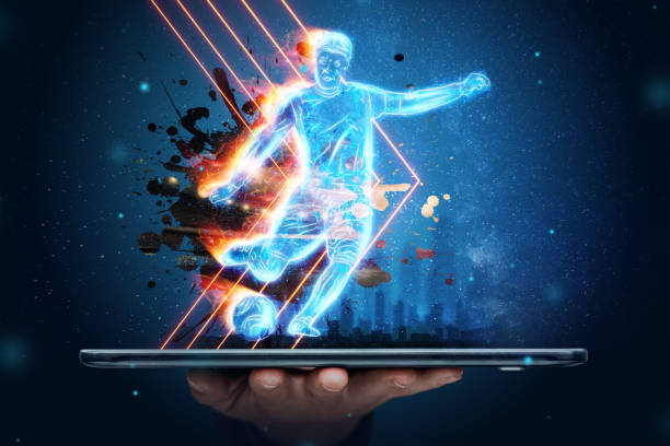 A hologram of a football player running out of a smartphone screen. The concept of sports betting, football, gambling, online broadcast of football. stock photo