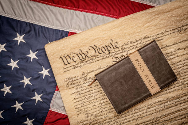 Holy bible and gun on constitution and American Flag stock photo
