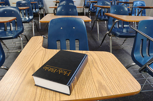 Holy Bible Lying on a Parochial School Desk stock photo