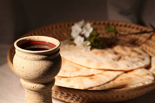Holy communion Chalice with red wine and pita bread in a basket.  last supper stock pictures, royalty-free photos & images