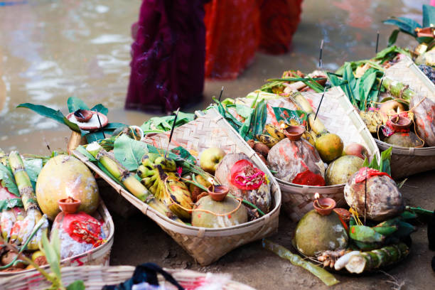 holy offerings of fruits flowers lamps and cloths in river to sun god on the occasion of chhath puja or chatt puja. holy offerings of fruits flowers lamps and cloths in river to sun god on the occasion of chhath puja or chatt puja. chhath stock pictures, royalty-free photos & images