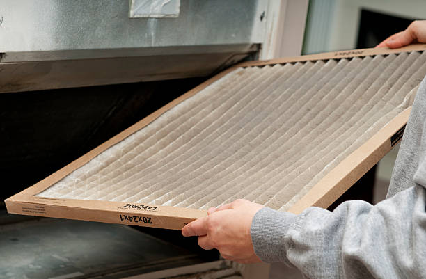 Home Air Filter Home owner changing their dirty air filter.   filtration stock pictures, royalty-free photos & images