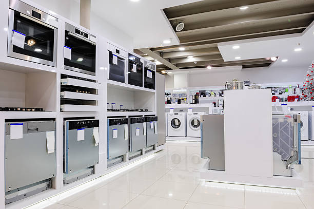 Home appliance in the store Gas and electric ovens and other home related appliance or equipment in the retail store showroom appliance stock pictures, royalty-free photos & images