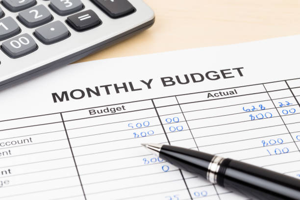 Home budget planning sheet with pen and calculator stock photo
