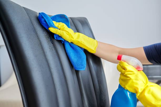 Home cleaning, woman in gloves with rag and spray with detergent washing leather chair Home cleaning, woman in gloves with rag and spray with detergent washing leather chair, close-up Office chair cleaning stock pictures, royalty-free photos & images