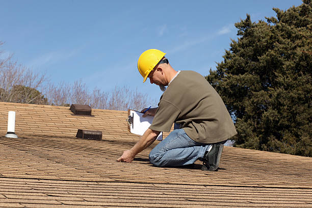 Home inspector checking the roof of a house. stock photo