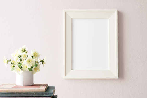 Home interior poster mock up with horizontal white frame on pink wall, decorative jar with plant, old books. 3D rendering. 3D Illustration stock photo