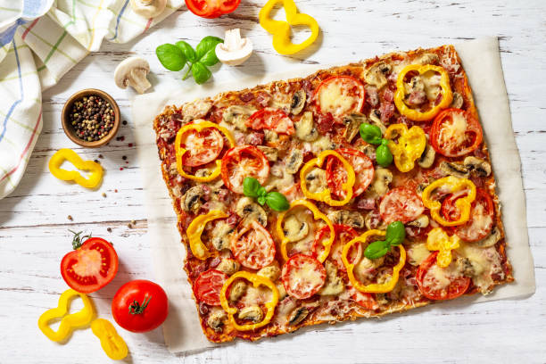 Home made baking. Detroit-Style Pizza. Large rectangular Pepperoni pizza with tomatoes, salami and cheese on a rustic wooden table. Top view. Flat lay. stock photo