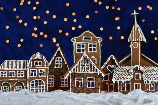 home made gingerbread village with bokeh sky stock photo