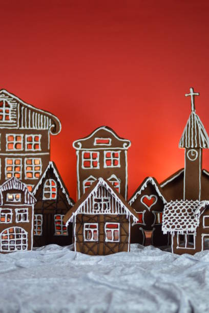 home made gingerbread village with red background stock photo
