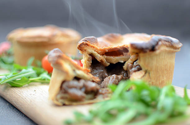 Home Made Meat Pie A home-made steak and ale meat pie.  meat pie stock pictures, royalty-free photos & images