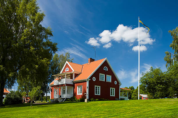 Home. Farm House in Sweden. Swedish flag on a flagpole. Home sweet home. sweden photos stock pictures, royalty-free photos & images