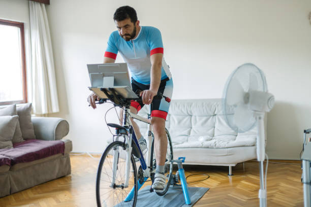 Home trainer with exercise bike Home trainer with exercise bike peloton stock pictures, royalty-free photos & images