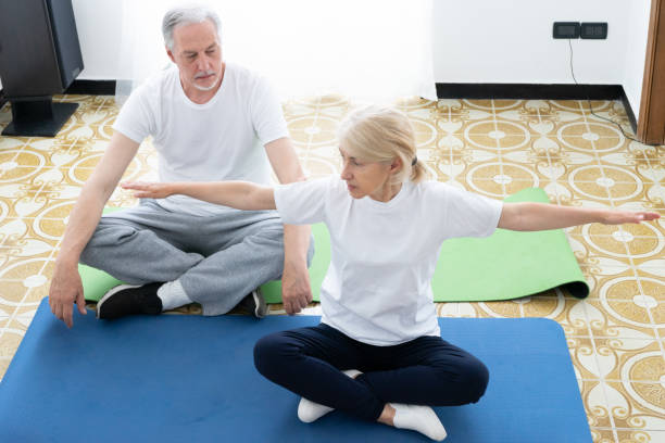Home Workout - Physical Therapist Teaching Patient How To Exercise At Home stock photo