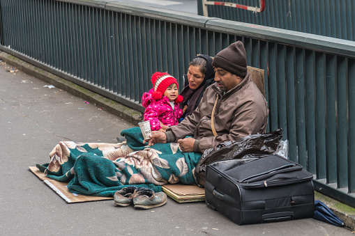 Homeless Family Sitting On The Street Stock Photo - Download Image Now ...