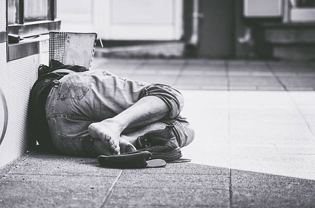 Homeless man sleep on the street stock photo