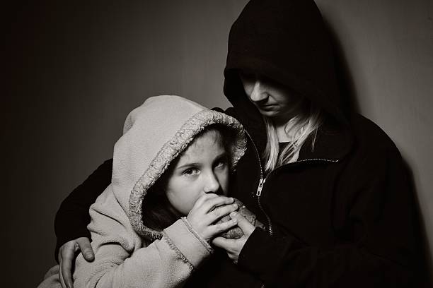 Homeless mother with her daughter. Poor family. stock photo