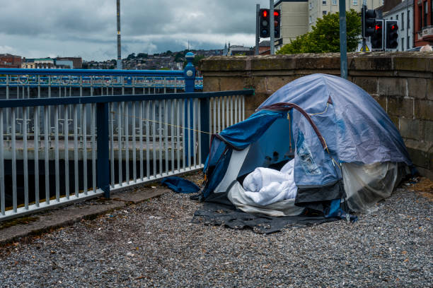 homeless tent by the river homeless tent by the river homelessness stock pictures, royalty-free photos & images