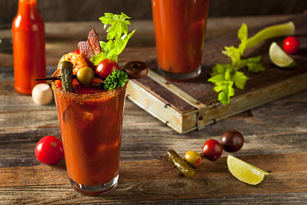 Homemade Bacon Spicy Vodka Bloody Mary Homemade Bacon Spicy Vodka Bloody Mary with Tomatos, Olive and Celery garnish stock pictures, royalty-free photos & images