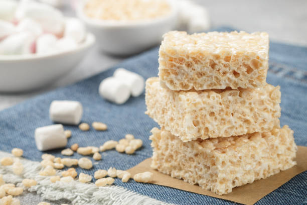 Homemade bars of Marshmallow and crispy rice and ingredients on the table. American dessert. Selective focus Homemade bars of Marshmallow and crispy rice and ingredients on the table. American dessert. Selective focus crunchy stock pictures, royalty-free photos & images