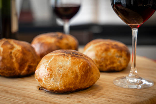 Homemade beef wellington and red wine glasses close up macro stock photo