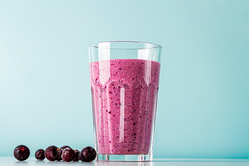 Homemade blueberry or currant smoothie with cottage cheese and fruits. Concept of proper nutrition and healthy eating. Organic and vegetarian drink.