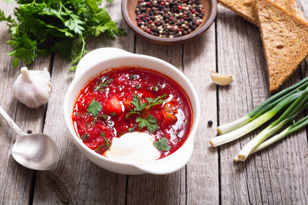 Homemade bowl with borscht and herbs stock photo