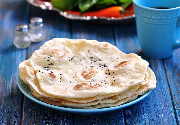 Homemade bread pita bread on a blue background. Homemade bread pita bread on a blue background. chapatti stock pictures, royalty-free photos & images