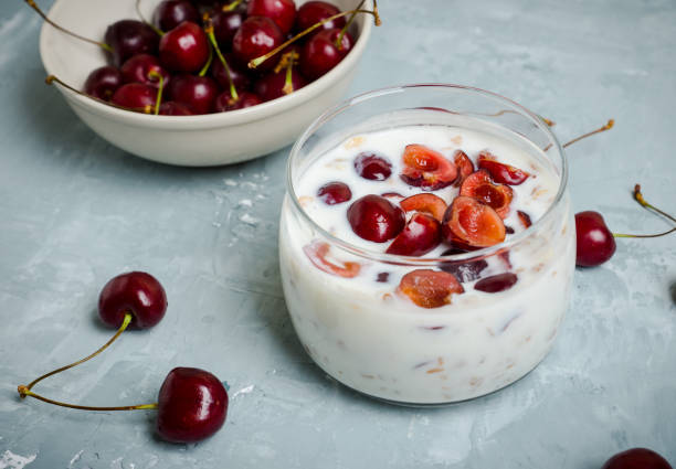 Homemade breakfast with white plain yogurt, muesli and cherries stock photo