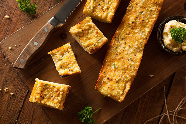 Homemade Cheesy Garlic Bread Homemade Cheesy Garlic Bread with Herbs and Spices garlic bread stock pictures, royalty-free photos & images