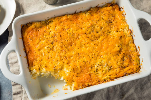 Homemade Cheesy Hashbrown Casserole Homemade Cheesy Hashbrown Casserole with Potatoes and Cream hash brown stock pictures, royalty-free photos & images