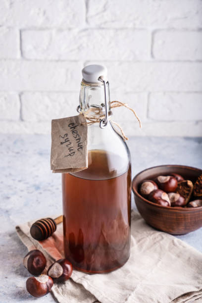 Homemade chestnut syrup in bottle Alternative food and drink Trend food 2020 Vertical stock photo