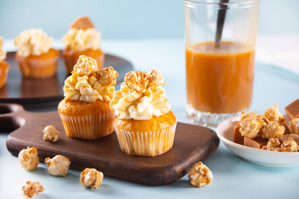 Homemade cupcakes with caramel popcorn and whipped cream cheese stock photo