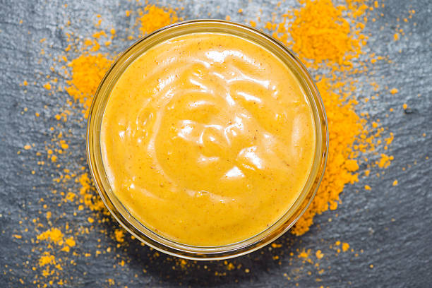 Homemade Curry Sauce Homemade Curry Sauce in a small bowl in vintage background curry powder stock pictures, royalty-free photos & images