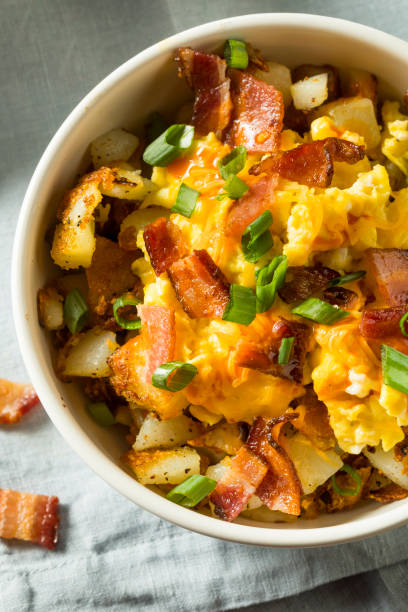 Homemade Egg and Potato Breakfast Bowl Homemade Egg and Potato Breakfast Bowl with Bacon hash brown stock pictures, royalty-free photos & images