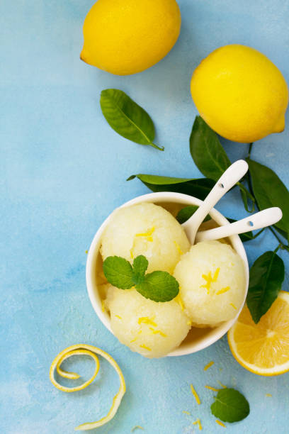 Homemade Fresh fruit lemon sorbet ice cream in a white bowl. Top view flat lay background with copy space. stock photo