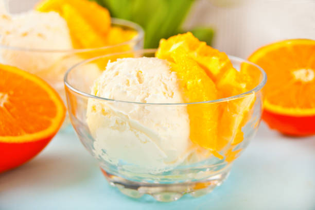 Homemade fresh orange ice cream with orange slices. Summer dessert. stock photo