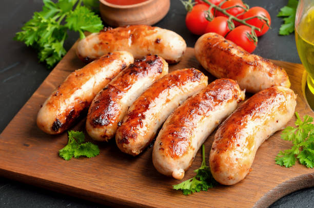 Homemade fried sausages on cutting board Homemade fried sausages on cutting board, close up view sausage photos stock pictures, royalty-free photos & images