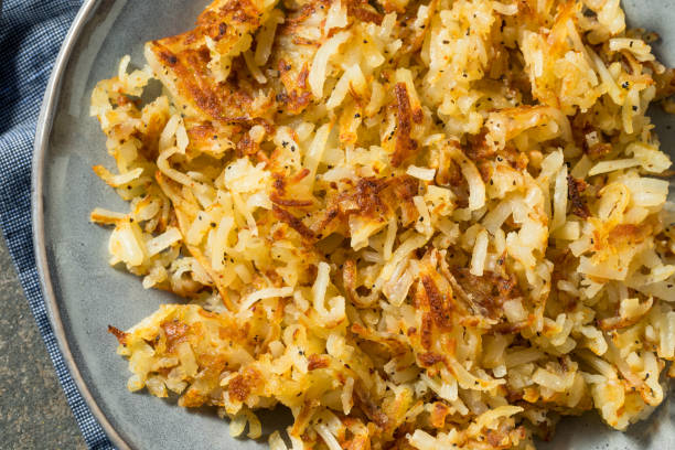 Homemade Fried Shredded Hashbrowns and Eggs Homemade Fried Shredded Hashbrowns and Eggs for Breakfast hash brown photos stock pictures, royalty-free photos & images